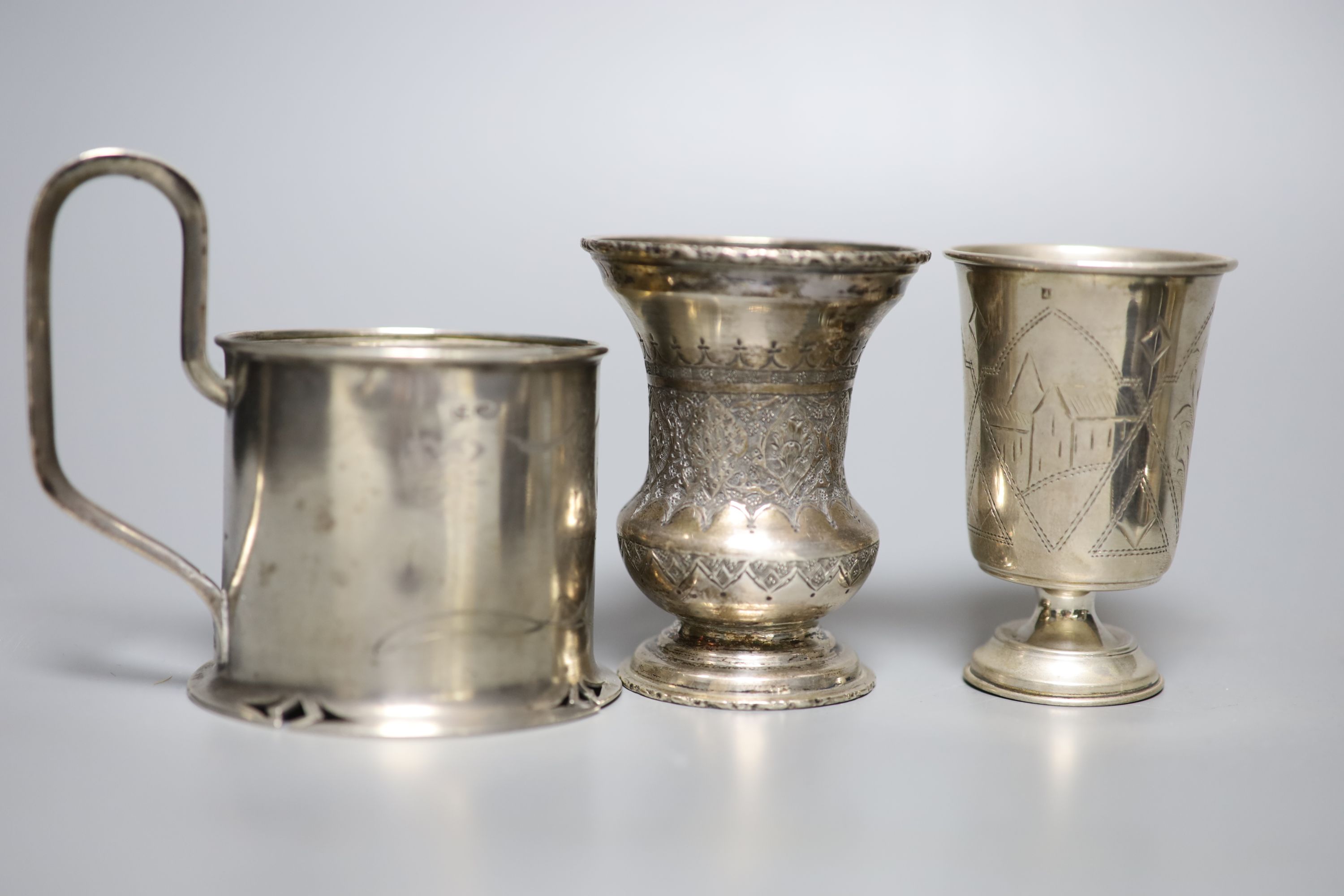 A group of six Russian early 20th century 84 zolotnik podstakanniks, two small vases, two tots and a salt